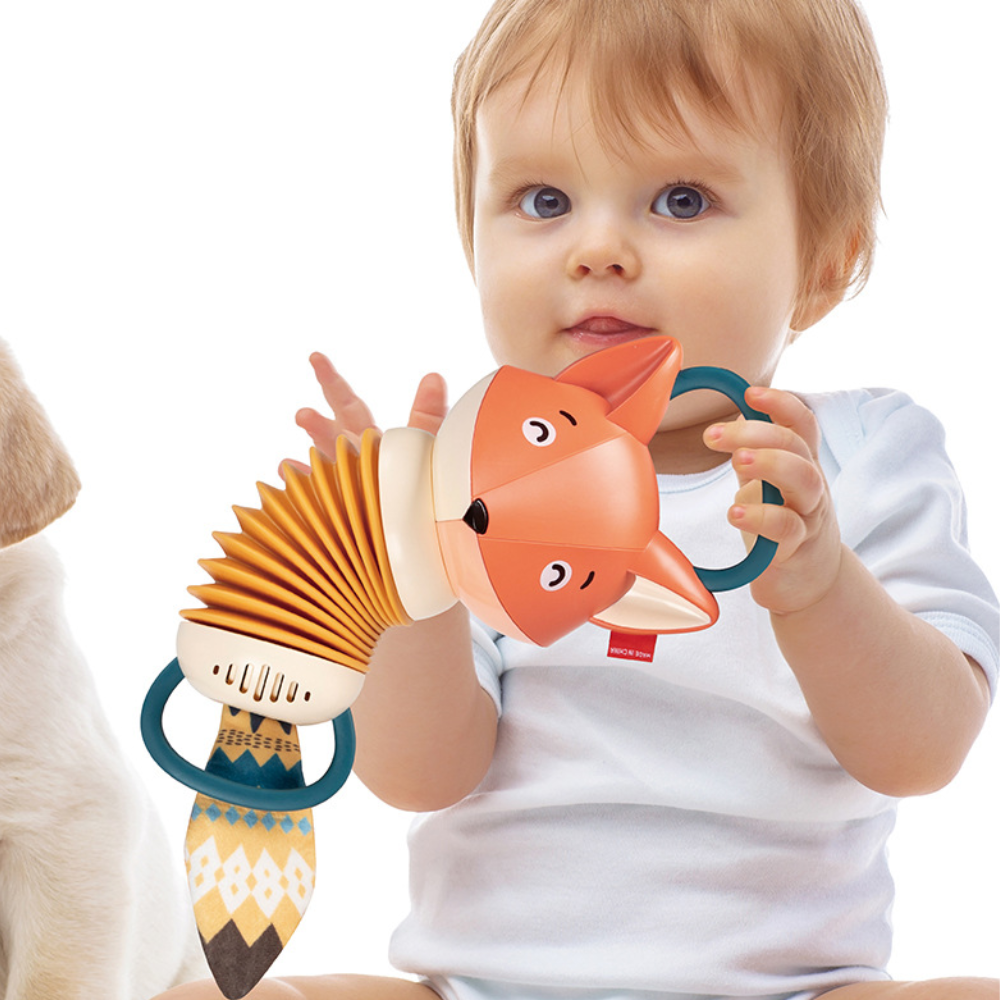 Child holding a colorful toy with a fox design on a white background